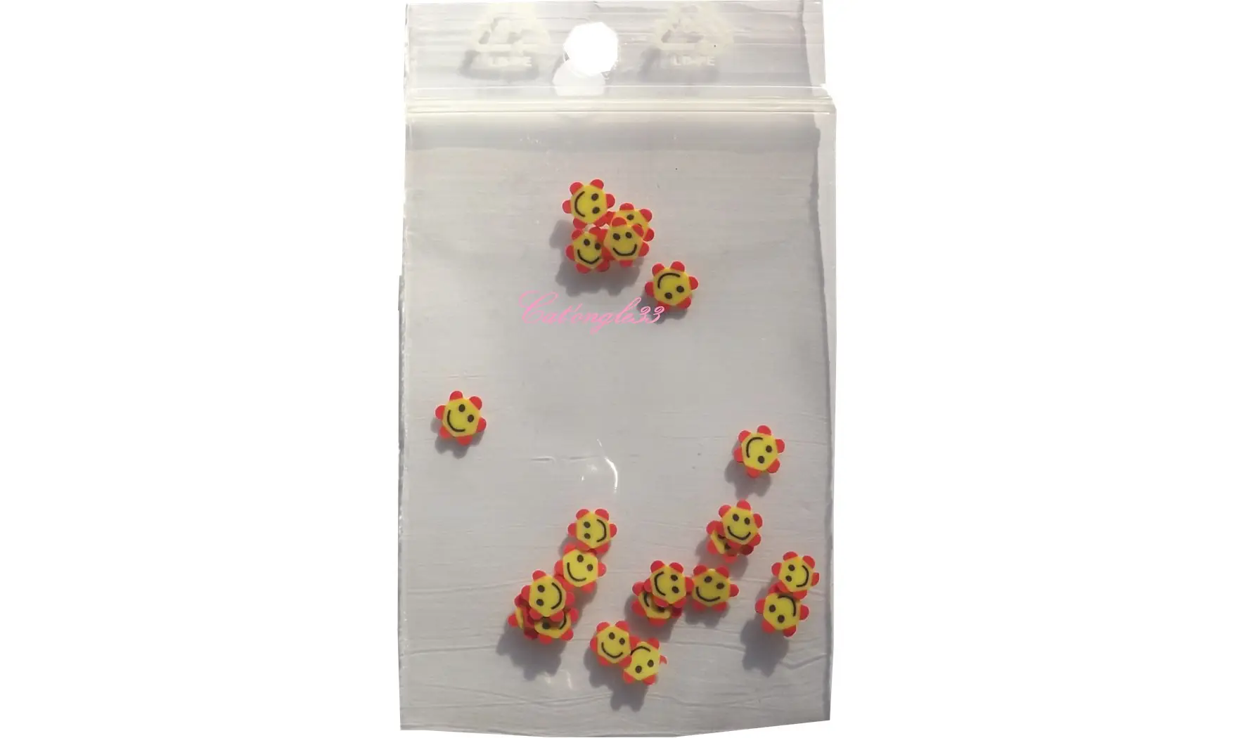 Sachet de fimo smiley fleur rouge