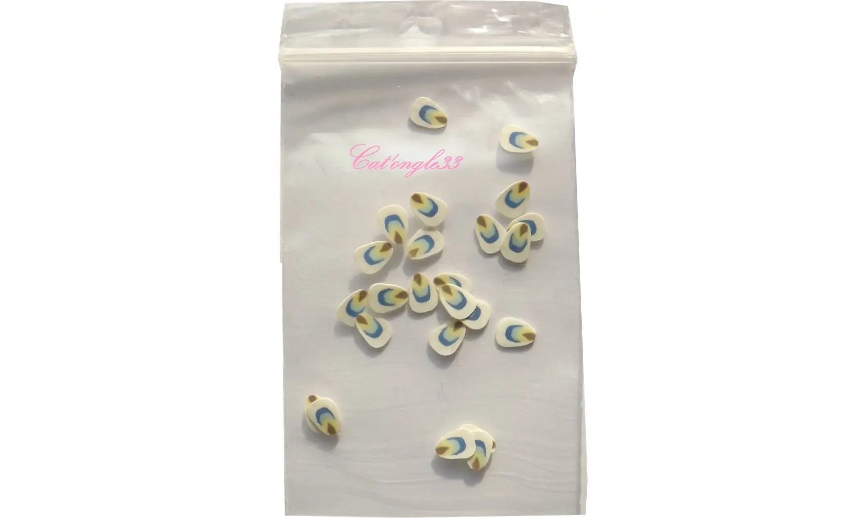 Sachet de fimo plume blanche multicoul.